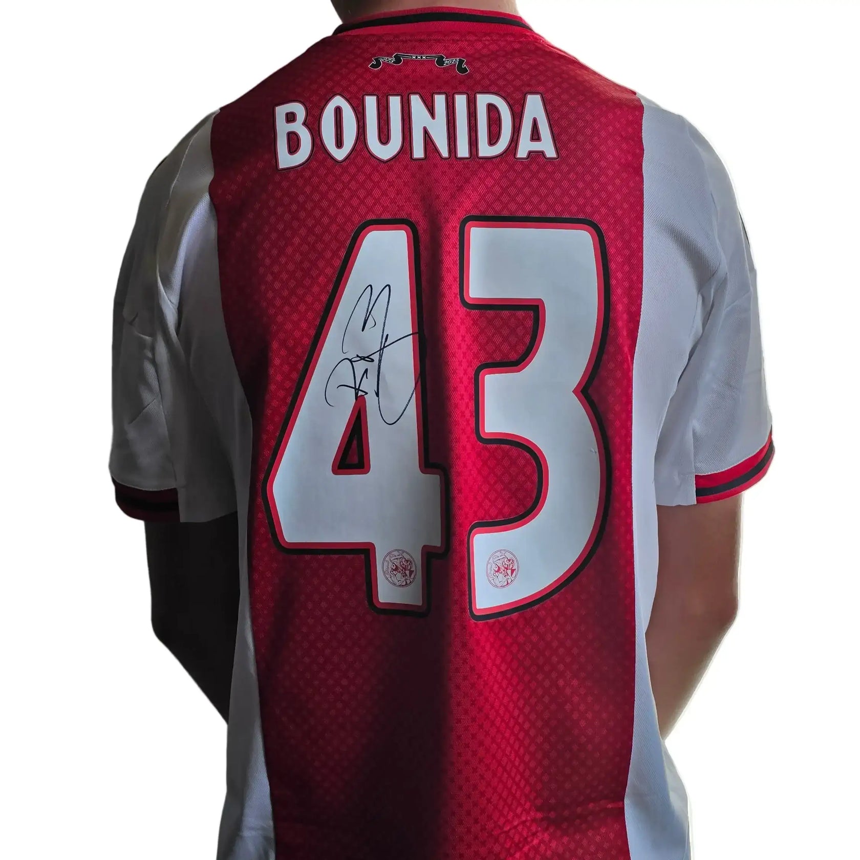 Back view of red Ajax shirt featuring 'BOUNIDA' and No. 43, signed in black ink.