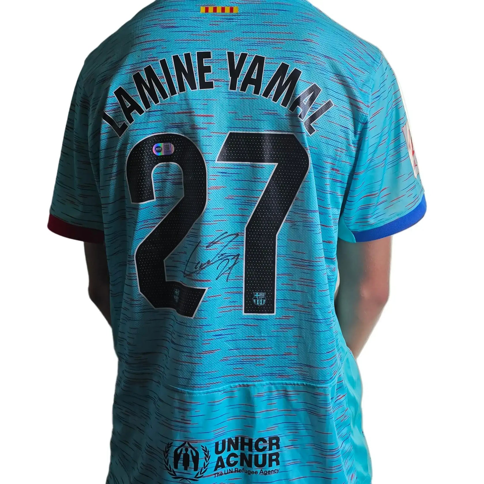 Lamine Yamal No. 27 Barcelona away shirt featuring a visible signature and UNHCR logo.