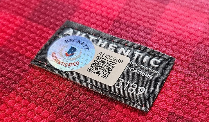 Close-up of an authenticity label on red shirt fabric. An independent verdict matters more to a collector than a seller's own assurance.