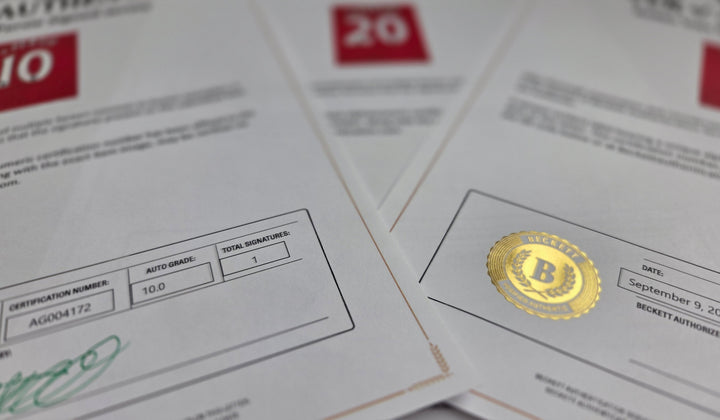 Overlapping Beckett certificates and an embossed gold seal, photographed close up. Paper records like these stay readable whether or not a database is online.