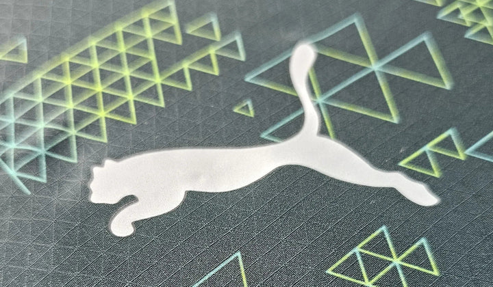 Macro shot of Puma logo printed on ULTRAWEAVE fabric with gradient geometric design from Manchester City fourth shirt.
