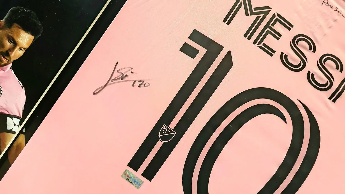 Signed Lionel Messi Inter Miami number 10 home shirt in pink, featuring his black autograph on the back, an iconic collectible for football fans and collectors.