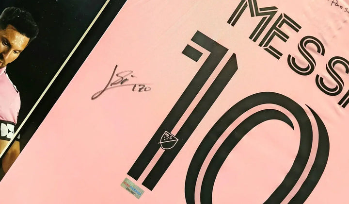 Signed Lionel Messi Inter Miami number 10 home shirt in pink, featuring his black autograph on the back, an iconic collectible for football fans and collectors.