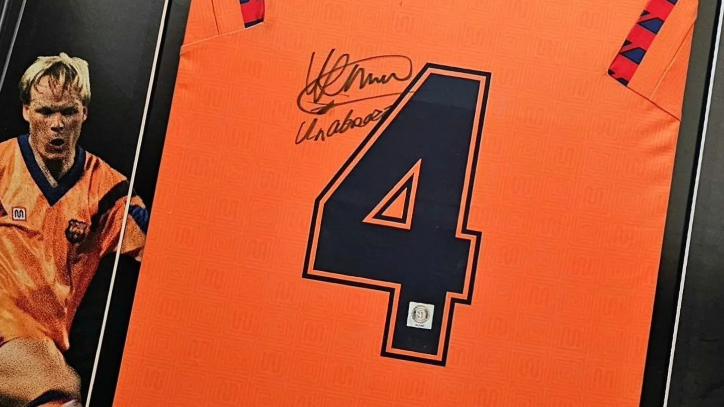 Signed Barcelona 1992 away football shirt number 4, worn in the club’s historic Europa Cup I victory, featuring Ronald Koeman’s autograph and photo of Koeman in action.