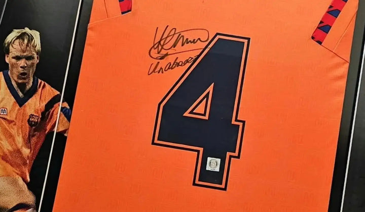 Signed Barcelona 1992 away football shirt number 4, worn in the club’s historic Europa Cup I victory, featuring Ronald Koeman’s autograph and photo of Koeman in action.