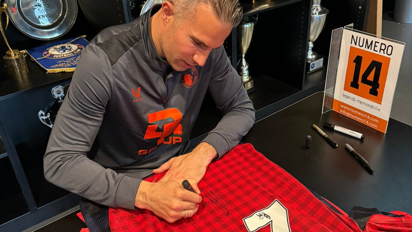Robin van Persie signing a red Manchester United football shirt, captured with Exact Photo Proof during a signing session, ensuring authenticity for collectors.