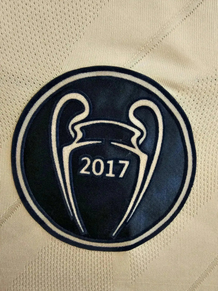 Crest detail featuring the UEFA Champions League trophy with 2017 on a white background.
