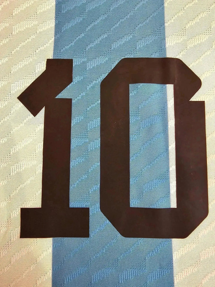Close-up of No. 10 on the blue and white striped soccer jersey, showing the number detail.