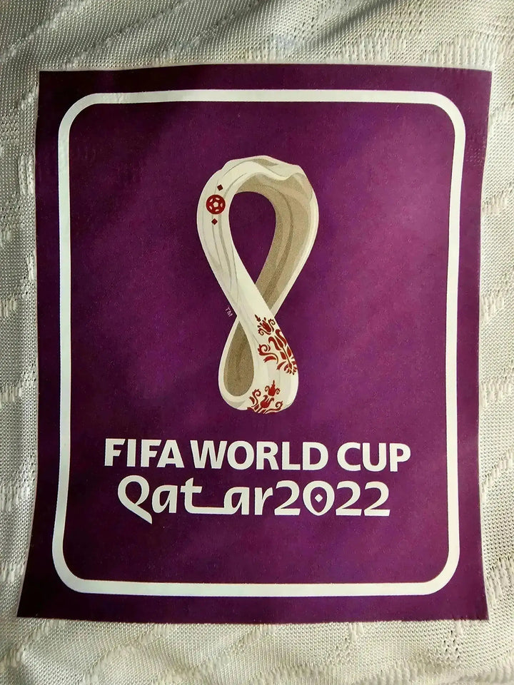 FIFA WORLD CUP Qatar 2022 logo detail featuring the tournament emblem in purple background.