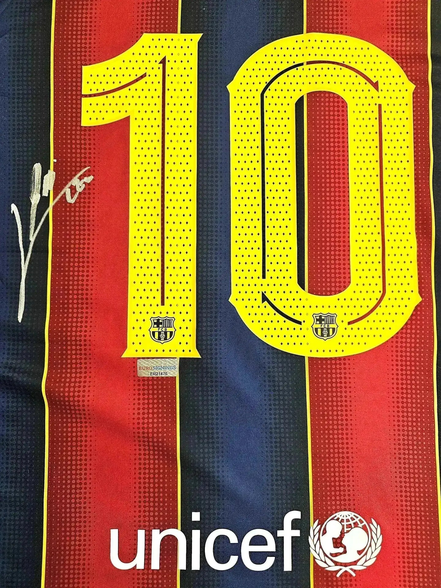 Detail view showing No. 10 and signature on FC Barcelona soccer jersey.