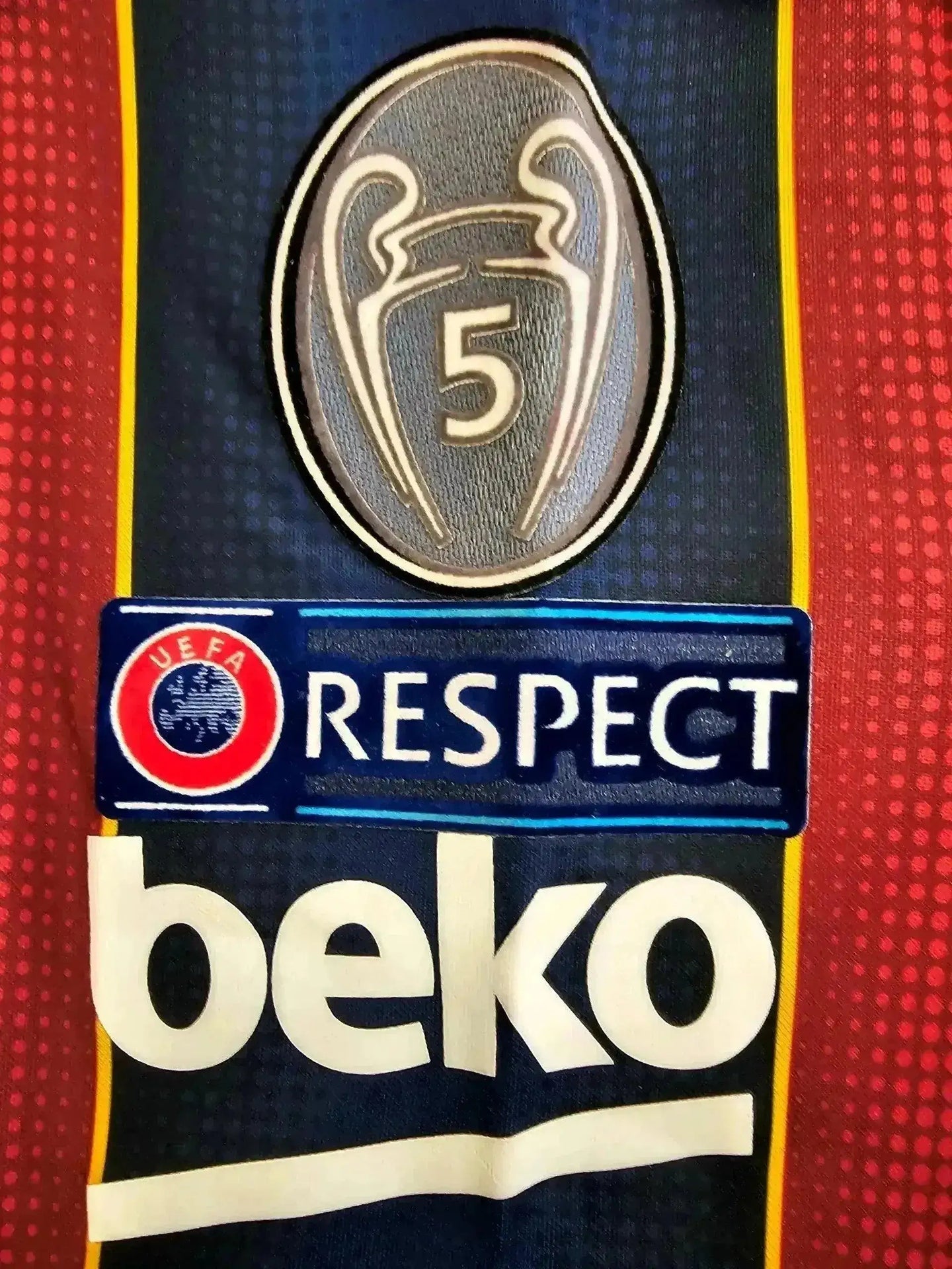 Close-up of FC Barcelona crest with five stars, UEFA Respect logo, and Beko sponsor branding.