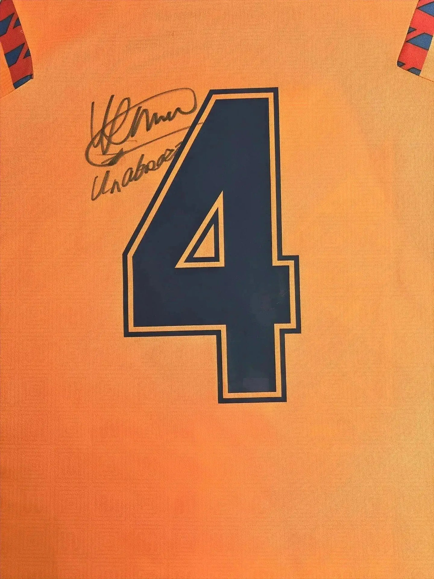 Detail view showing signature and No. 4 on Ronald Koeman's signed Barcelona away football shirt.