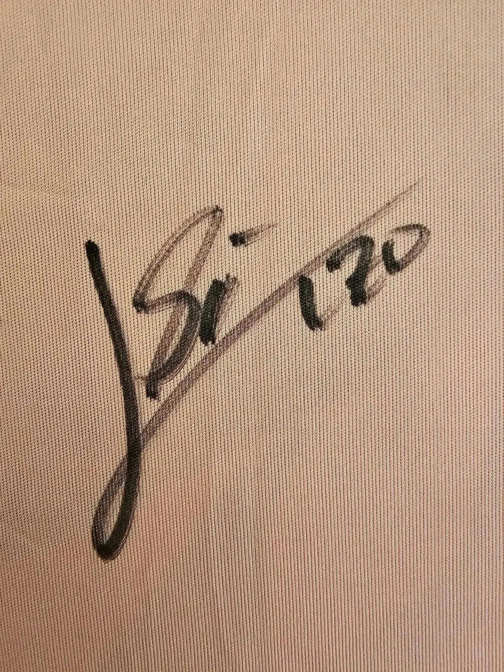 Close-up of signature detail on a signed soccer jersey by Lionel Messi.