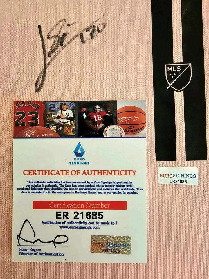 Detail view showing the signature on a Lionel Messi signed soccer jersey with the MLS crest.