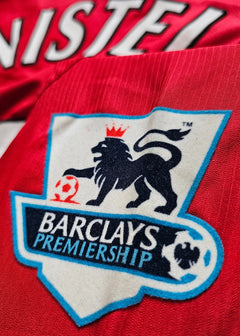 Close-up of the crest detail featuring the Barclays Premiership logo on a red shirt.