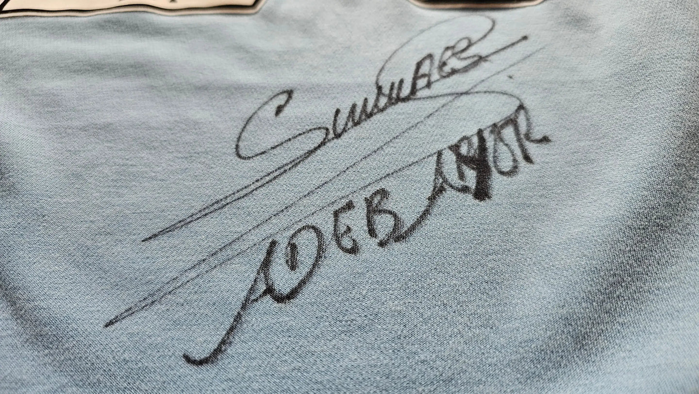Close-up of a signature of Emmanuel Adebayor on a textured surface