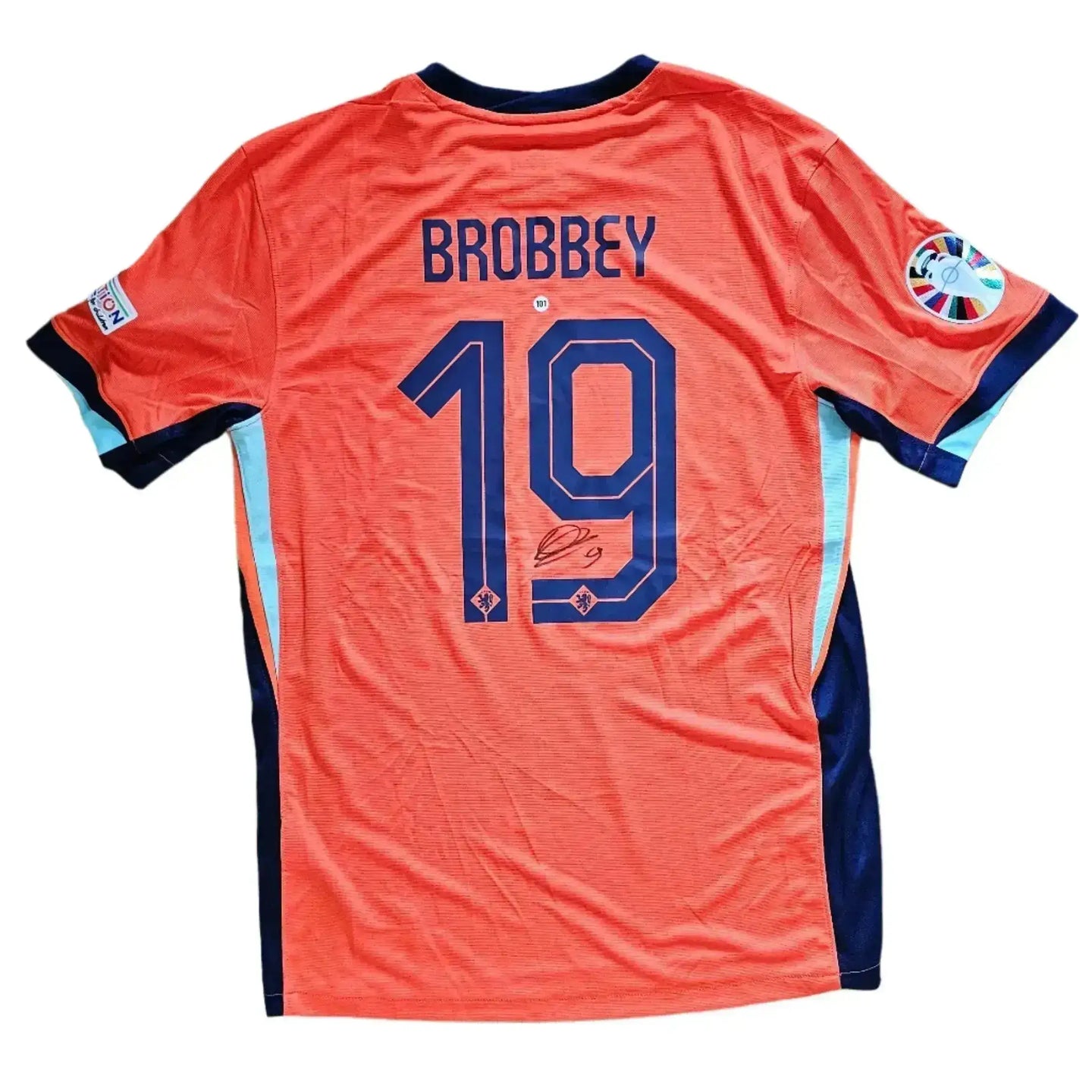 Back view showing Brobbey, No. 19 and signature on an orange football shirt.