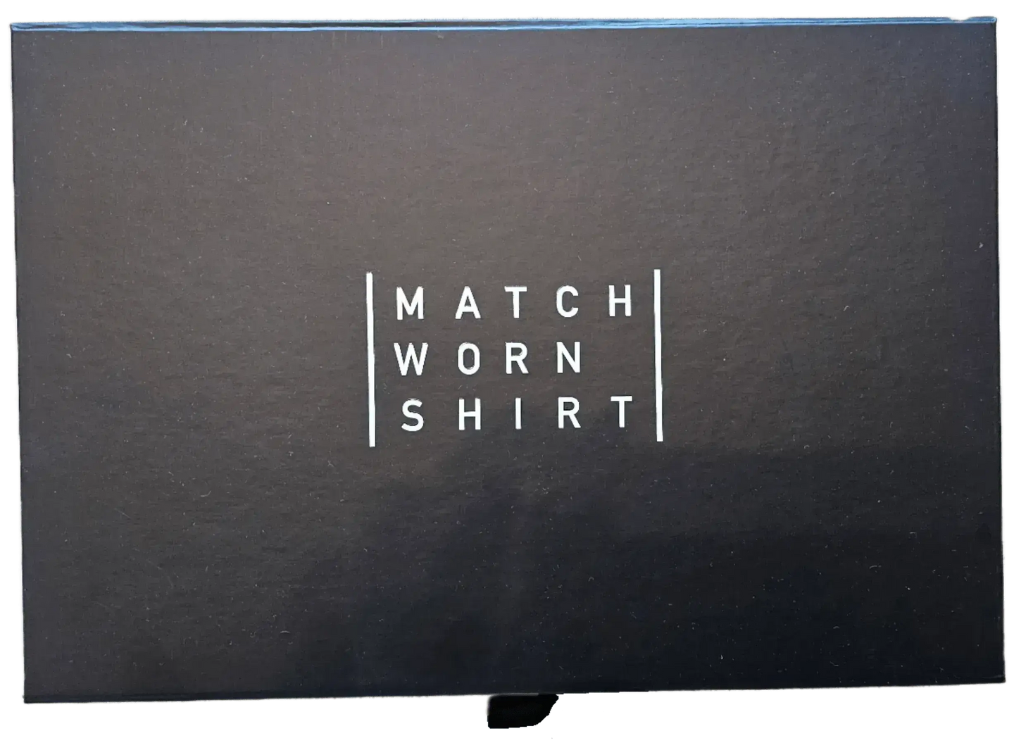 Black box featuring the text 'MATCH WORN SHIRT' in white lettering.