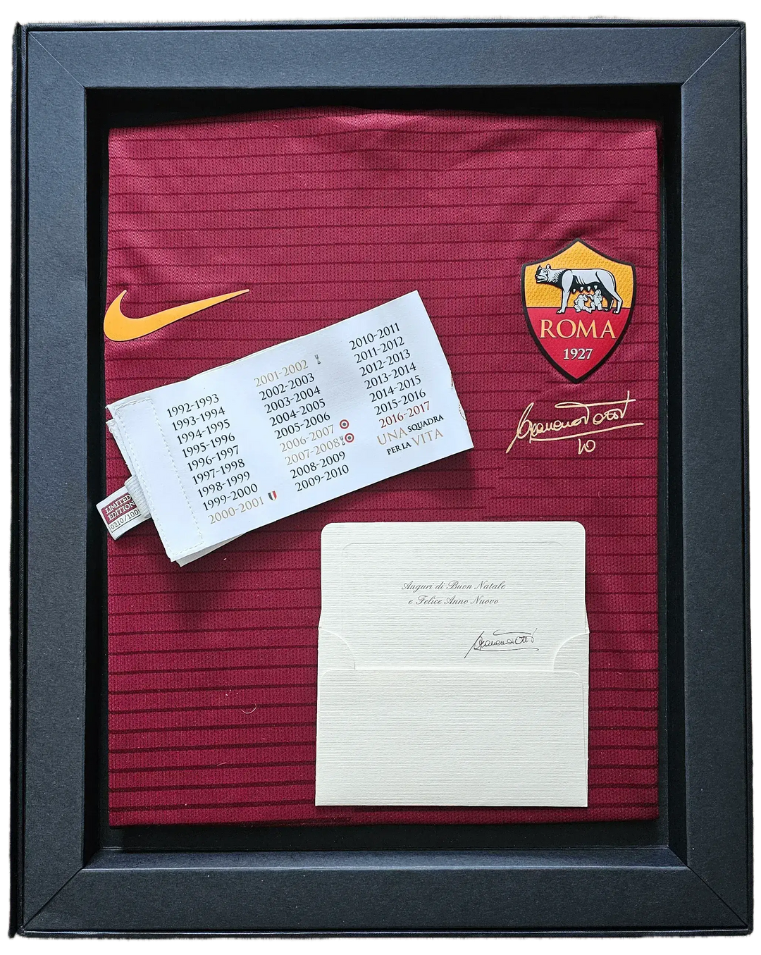 Francesco Totti No. 10 Roma football shirt with signature and commemorative details displayed.