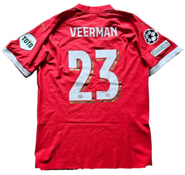 Back view showing Veerman, No. 23, and a visible signature on the red football shirt.