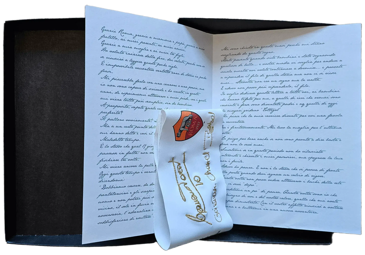 Booklet with handwritten notes and Roma crest, featuring signed message from Totti.