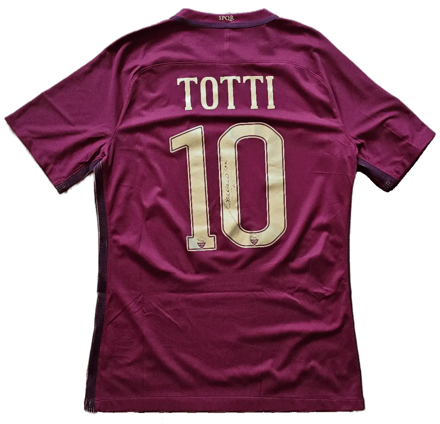 Back view showing No. 10 and signature of Totti on a maroon football shirt.