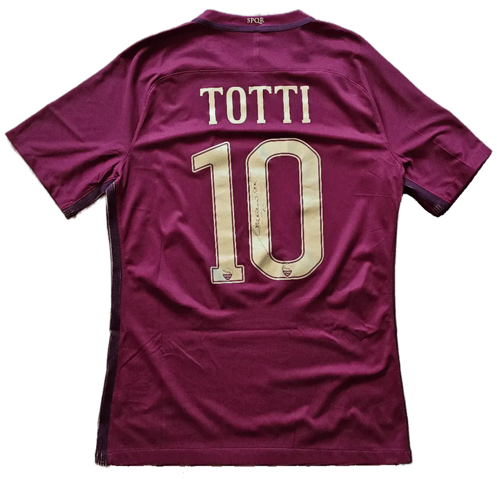 Back view showing No. 10 and signature of Totti on a maroon football shirt.