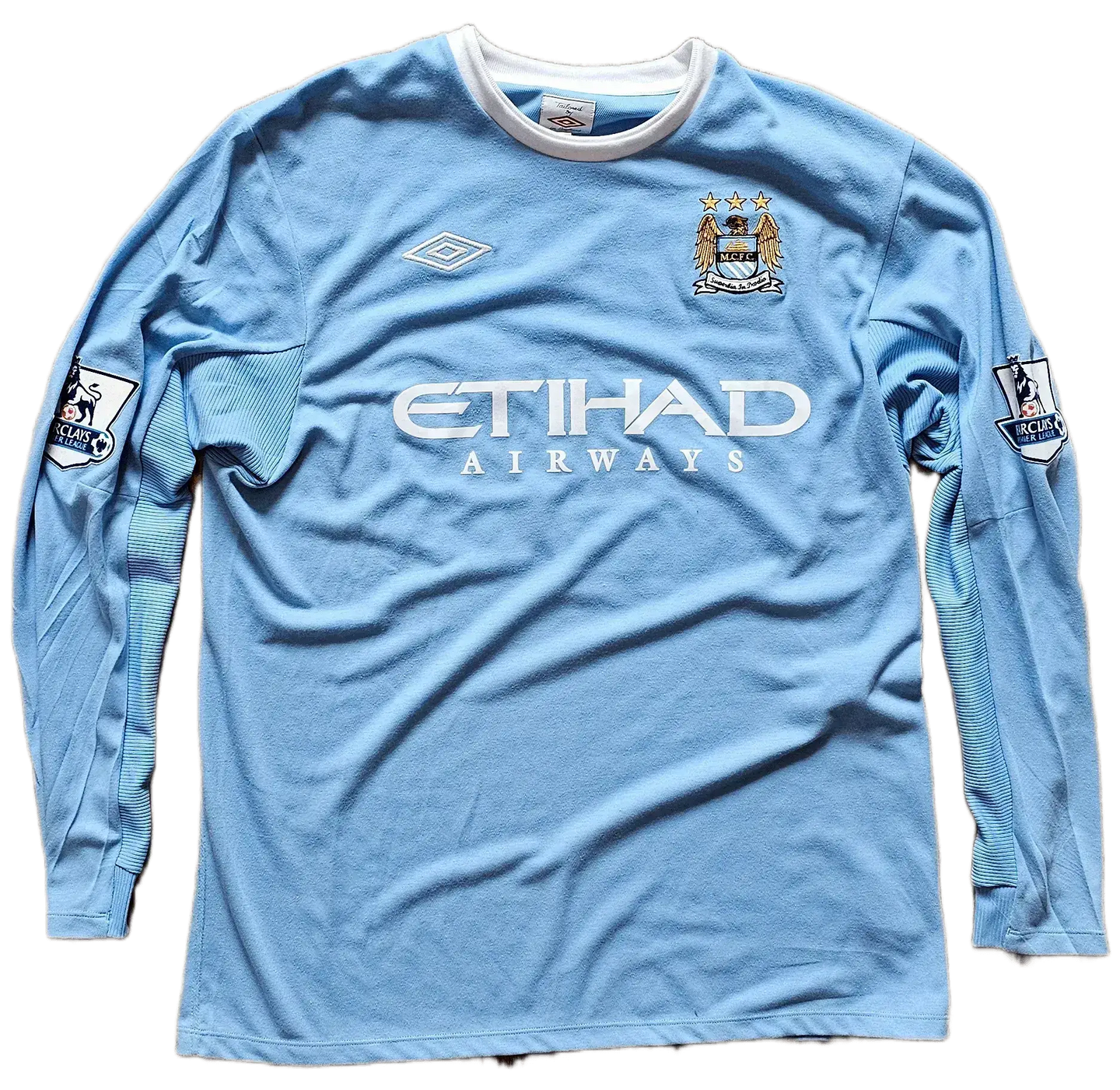Front view of signed Manchester City soccer jersey with ETIHAD AIRWAYS sponsor and club crest.