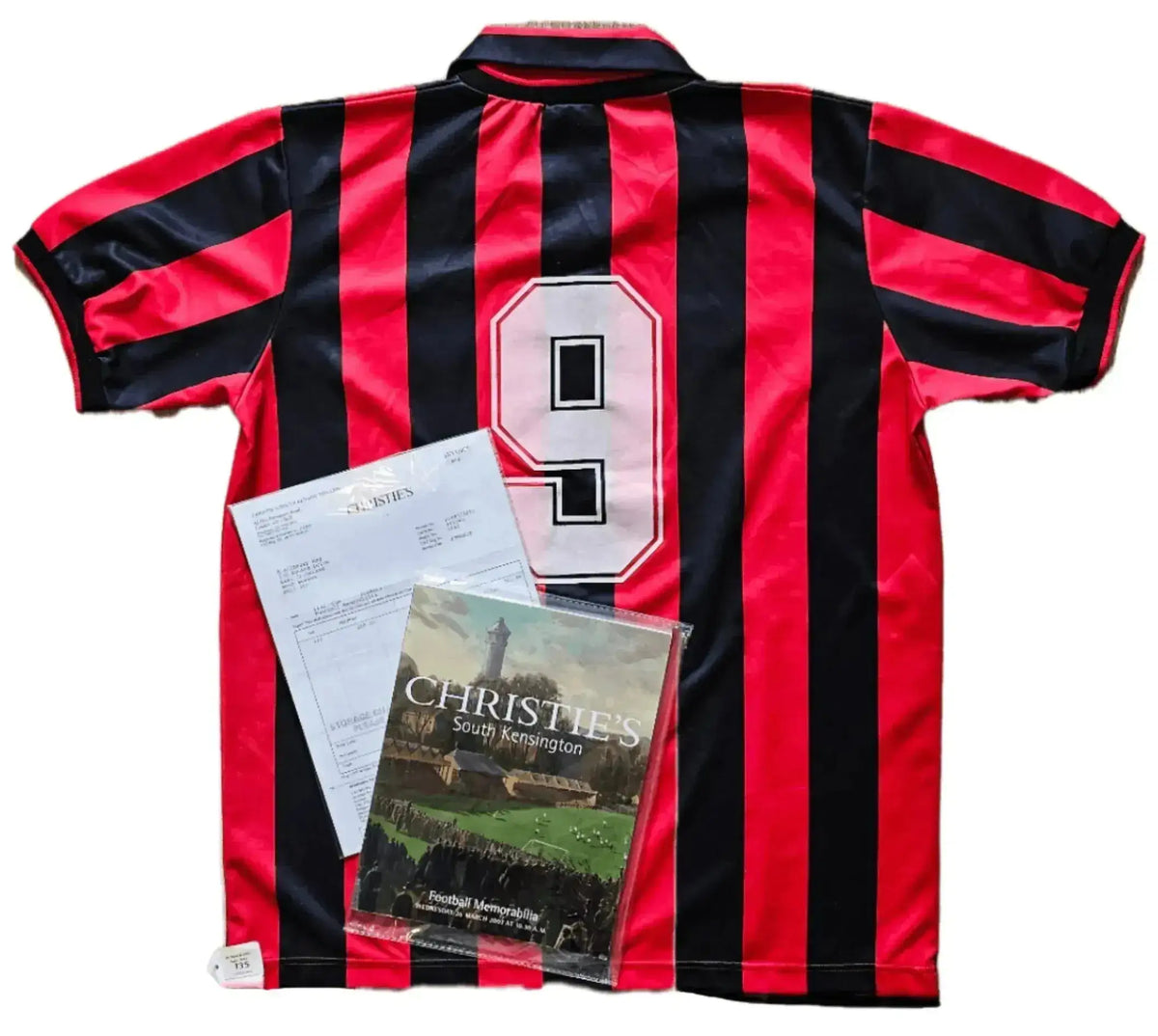 Back view showing No. 9 on a red and black striped AC Milan football shirt.