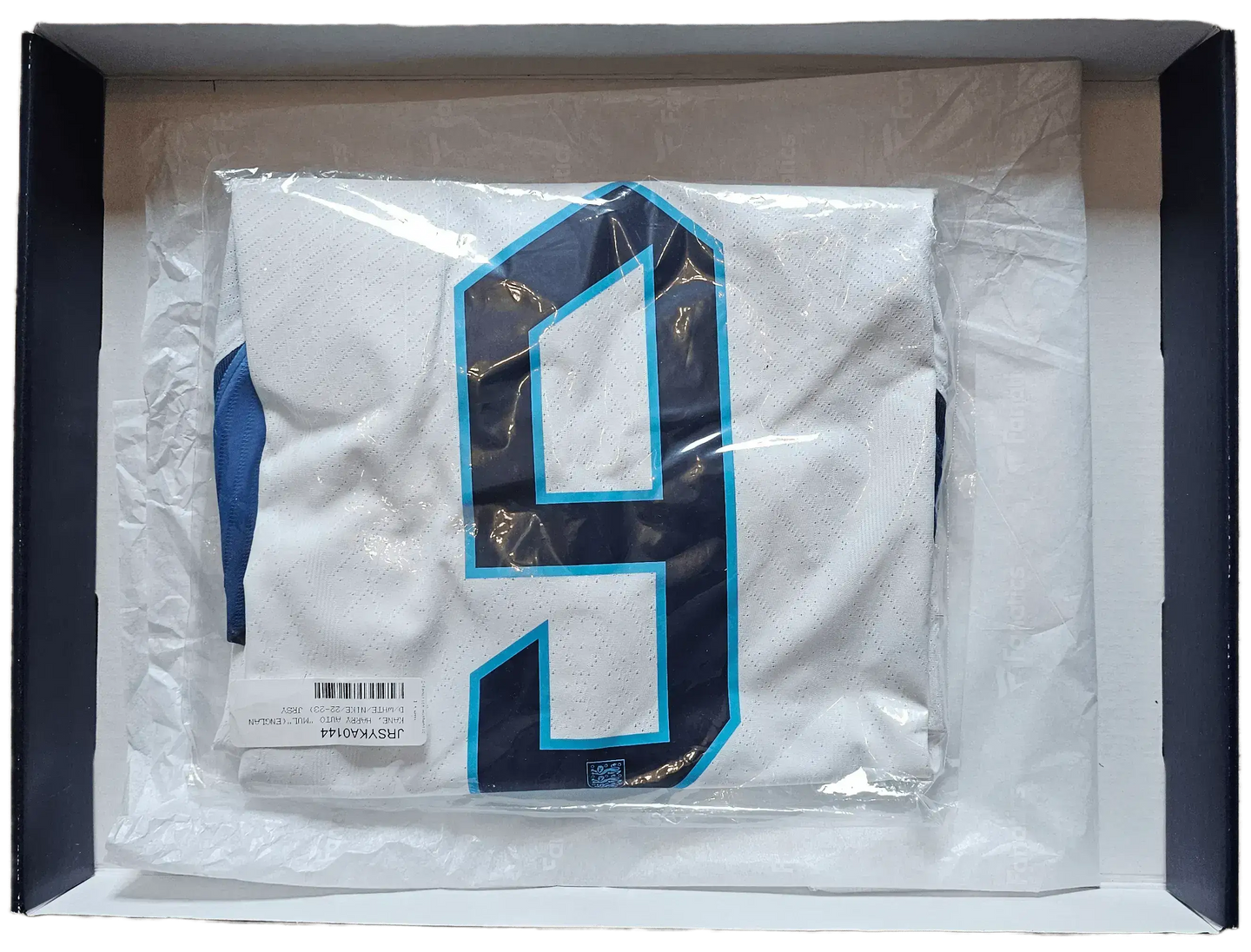 Back view showing No. 9 on white football shirt with navy details in packaging.