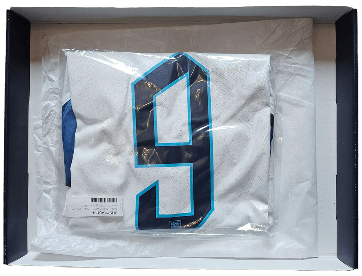 Back view showing No. 9 on white football shirt with navy details in packaging.