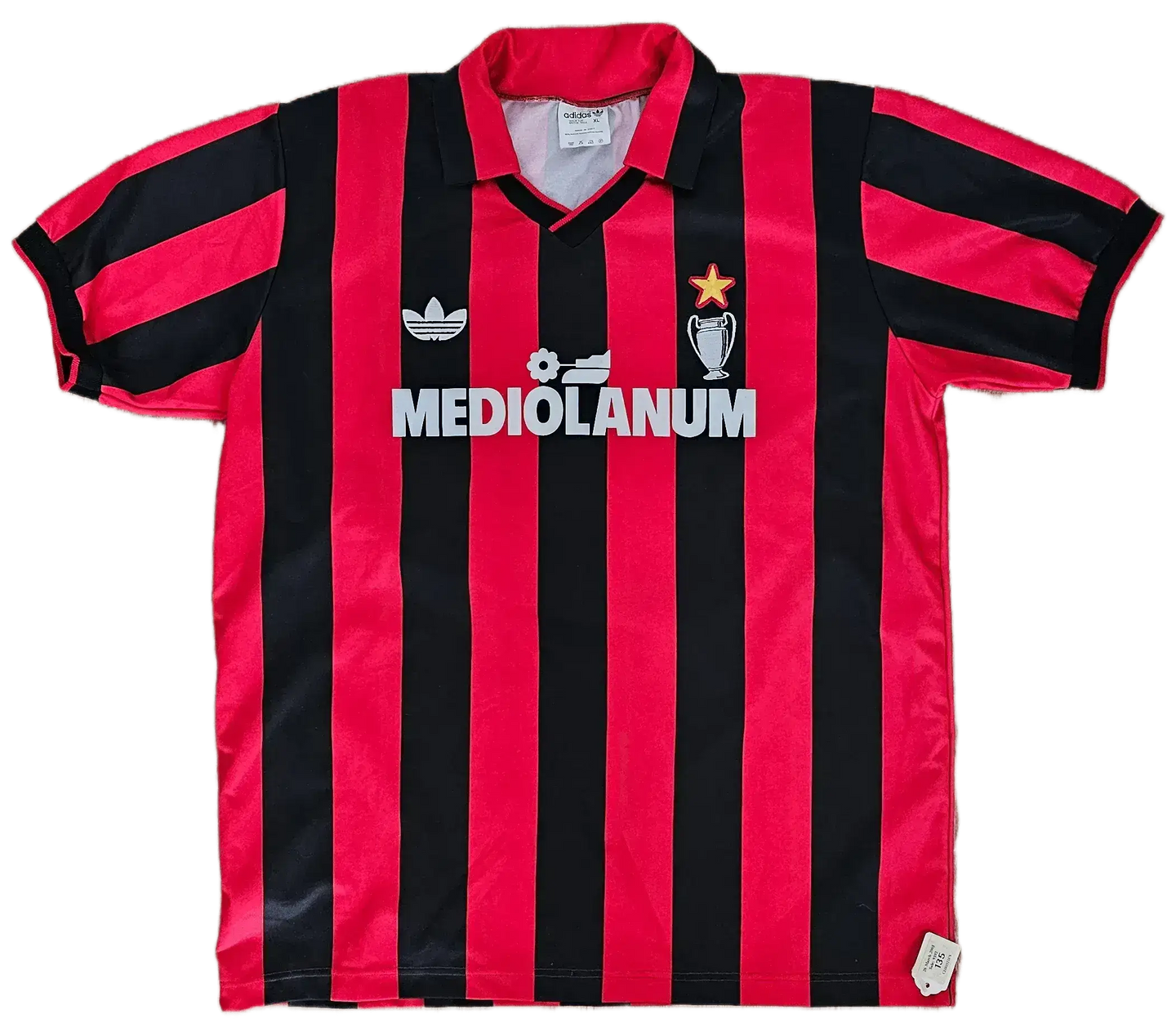 Back view of AC Milan football shirt with black and red stripes, featuring the MEDIOLANUM logo and a star.