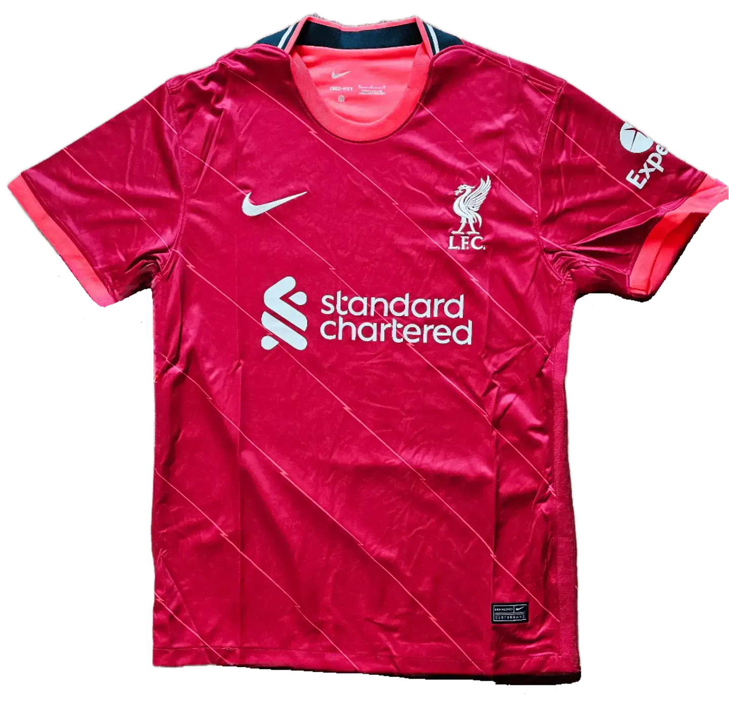 Front view of a signed Liverpool F.C. soccer jersey featuring the crest and 'standard chartered' sponsor.