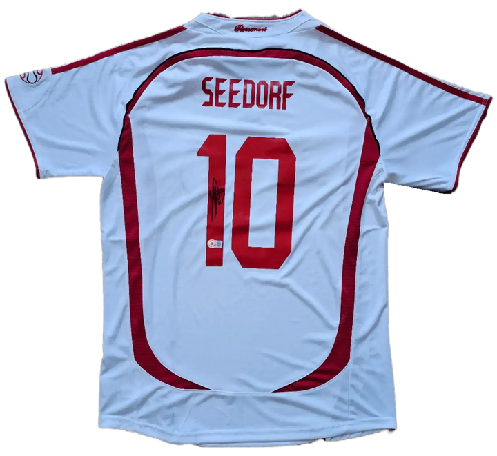 Back view showcasing Seedorf, No. 10, with visible signature on the white AC Milan football shirt.