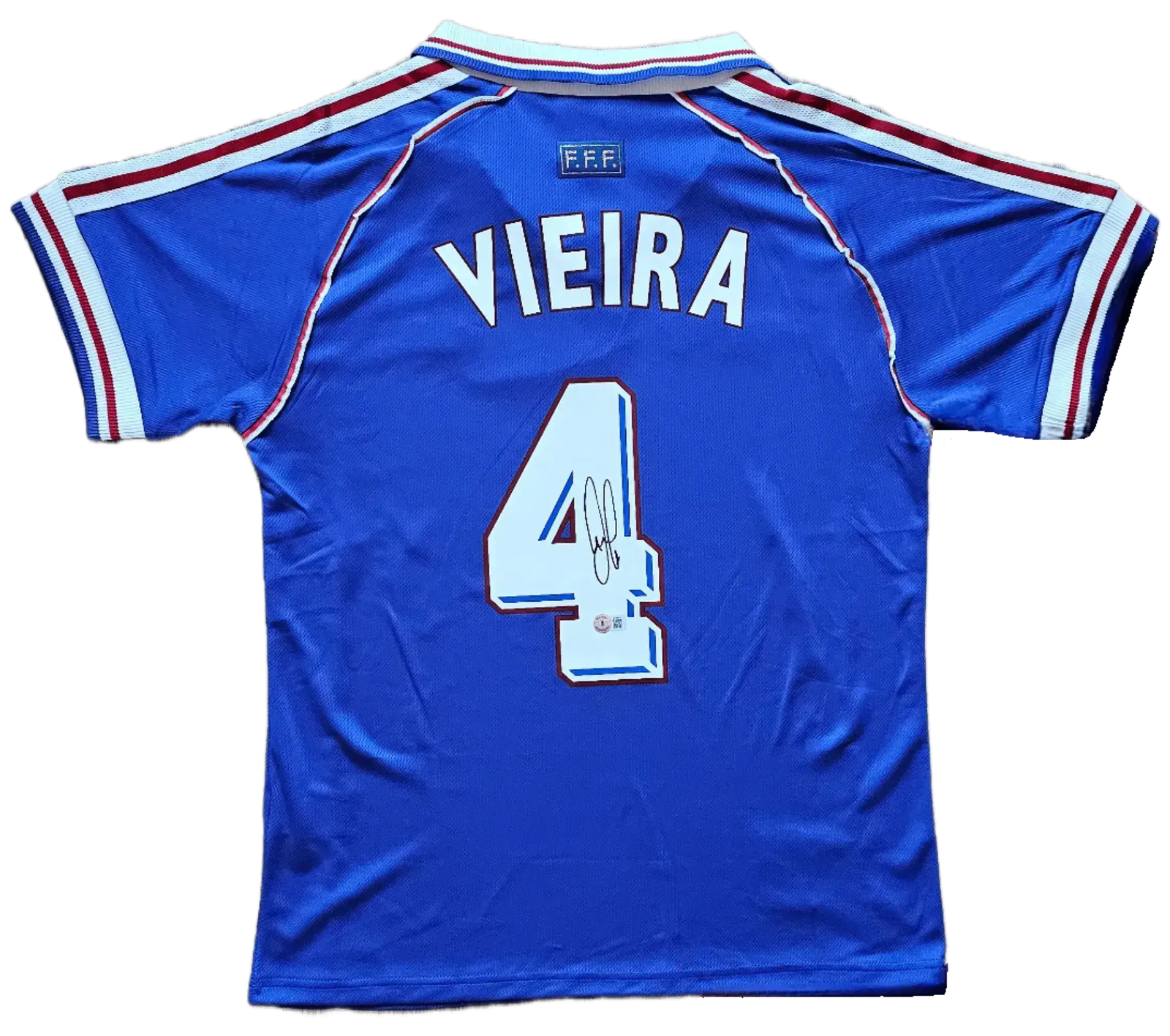 Back view showing Vieira and No. 4 with a visible signature on blue soccer jersey.