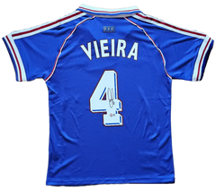 Back view showing Vieira and No. 4 with a visible signature on blue soccer jersey.