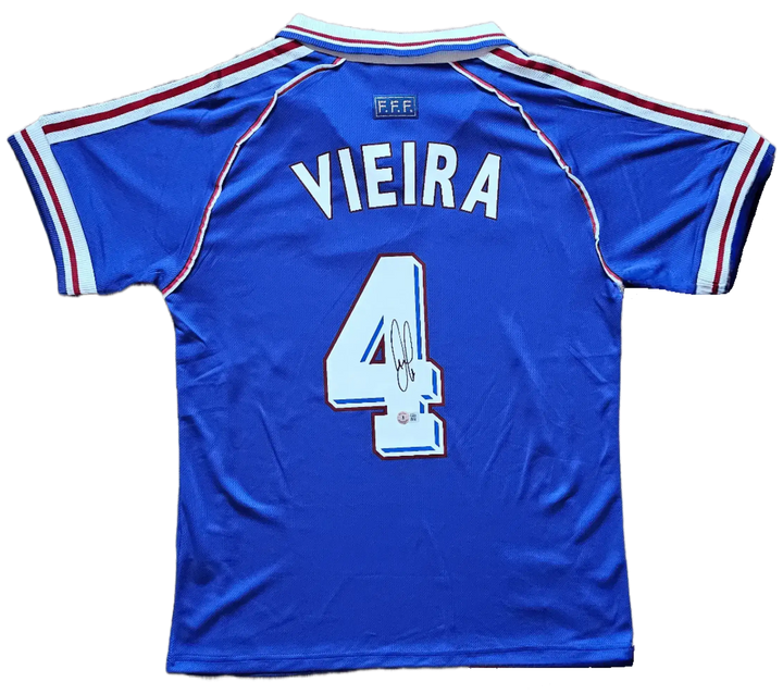 Back view showing Vieira and No. 4 with a visible signature on blue soccer jersey.
