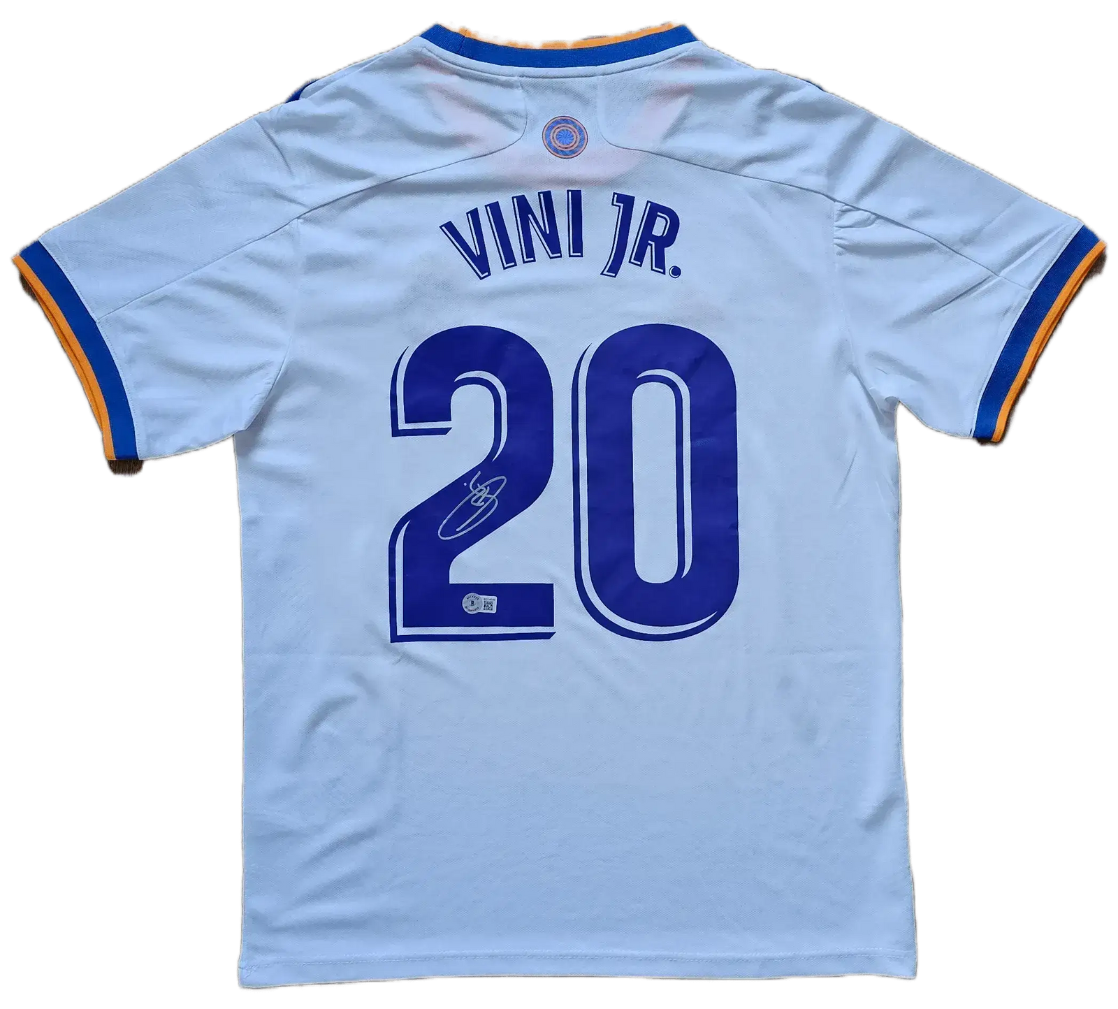 Back view showing No. 20 and signature of Vinícius Junior on a Real Madrid soccer jersey.