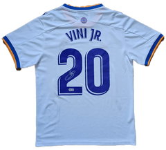 Back view showing No. 20 and signature of Vinícius Junior on a Real Madrid soccer jersey.