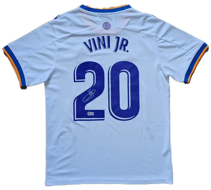 Back view showing No. 20 and signature of Vinícius Junior on a Real Madrid football shirt.