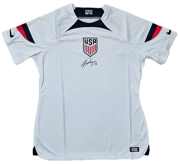 Front view of USA soccer jersey featuring crest, player name USA, and signature by Morgan.