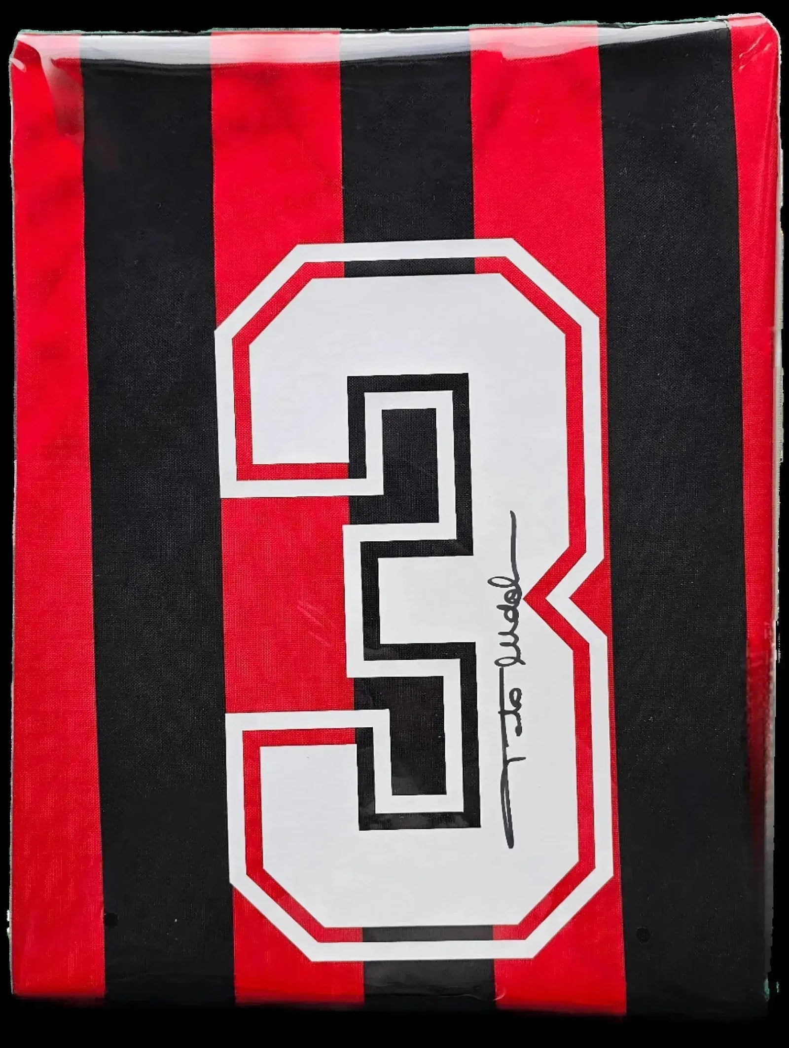 Back view showing No. 3 with signature on red and black striped football shirt.