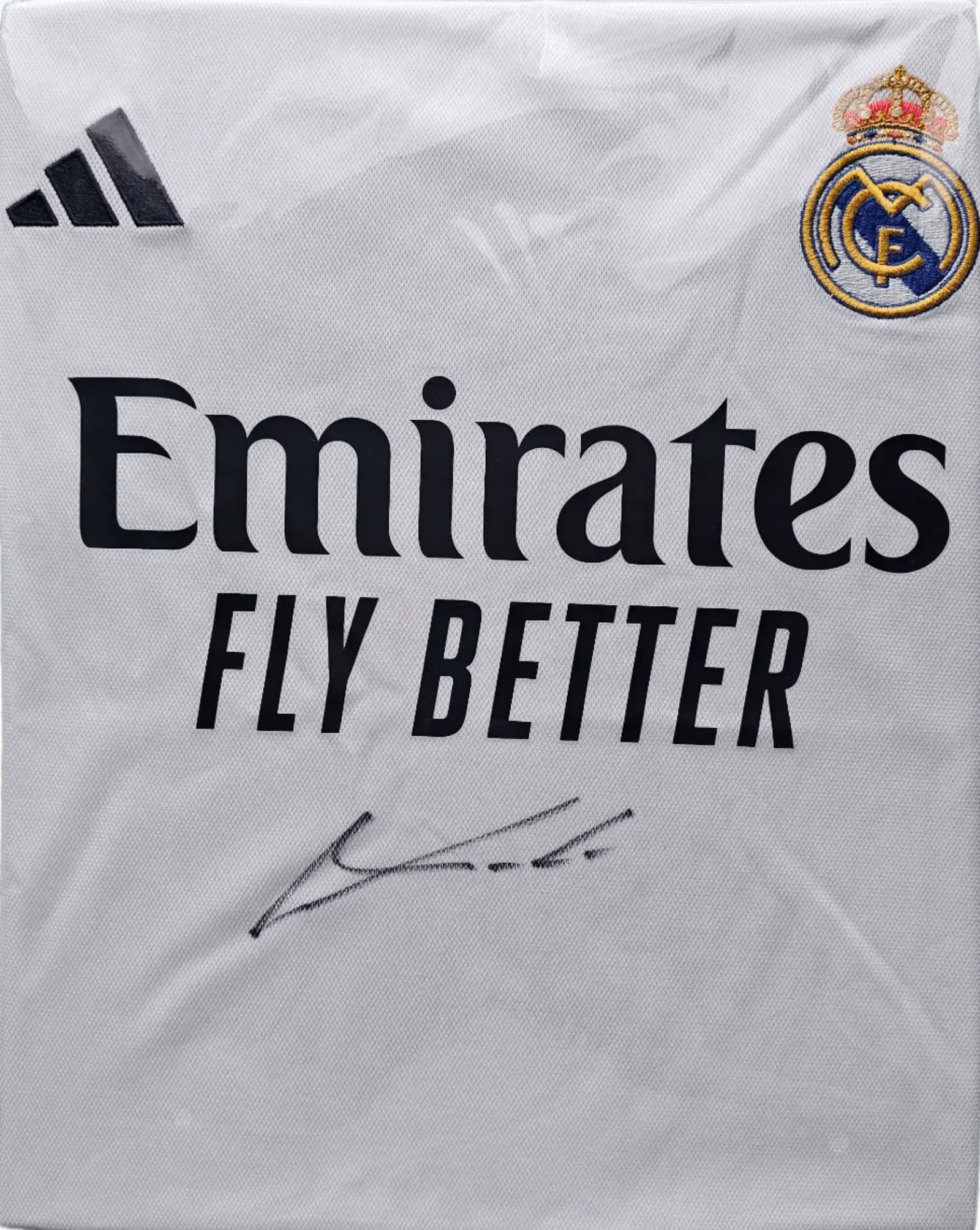 Front view highlighting the Real Madrid crest, Emirates sponsor, and Luka Modrić's signature.