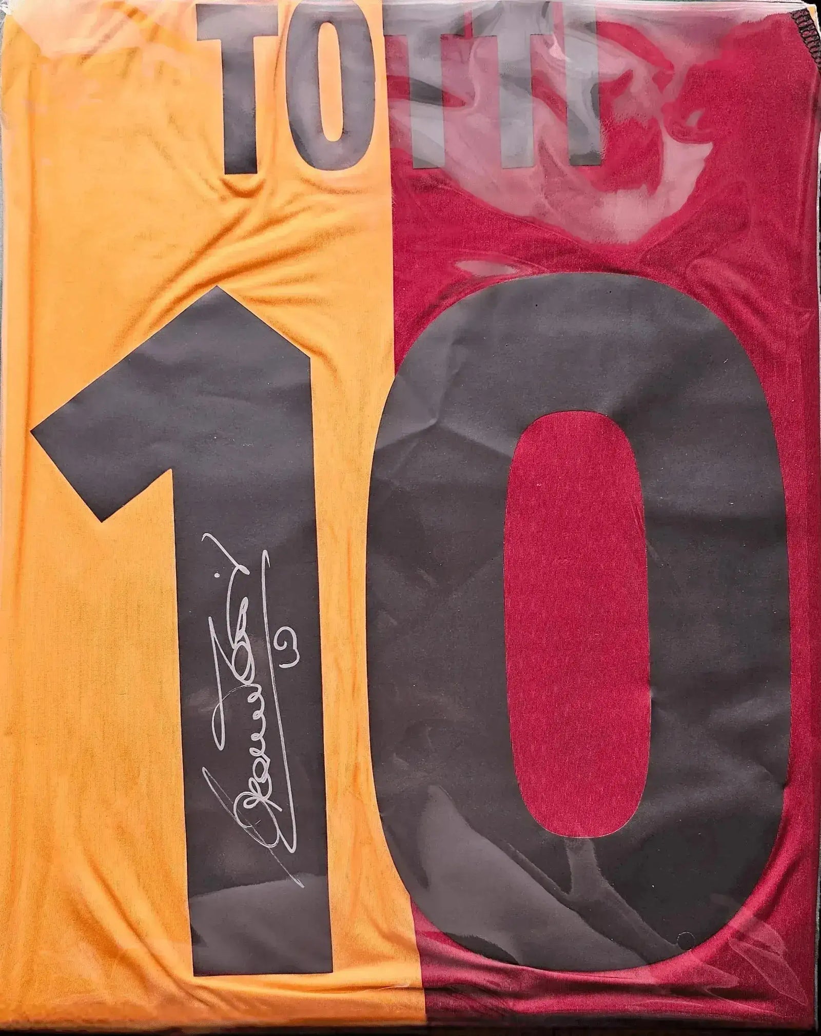 AS Roma football shirt featuring Totti's name and No. 10, with signature detail.