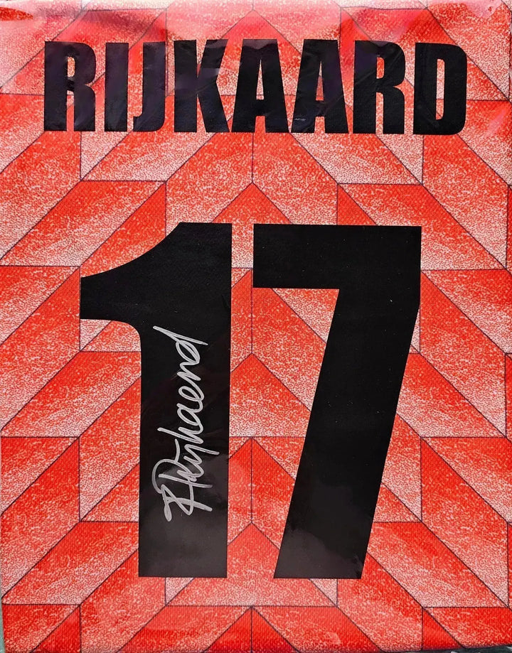 Back view showing the name Rijkaard and number 17 in black on a red patterned background.