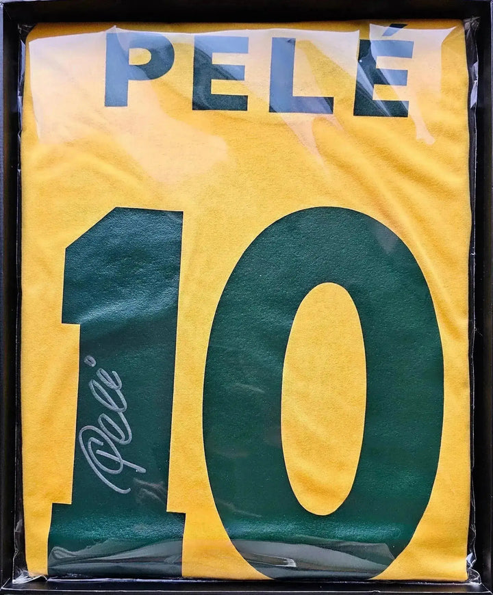 Front view of signed yellow Brazil football shirt with name Pelé and No. 10 visible.