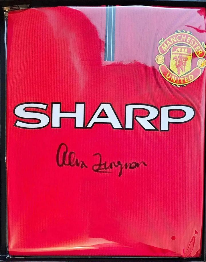 Front view of signed Manchester United football shirt featuring the Sharp logo and signature of Alex Ferguson.