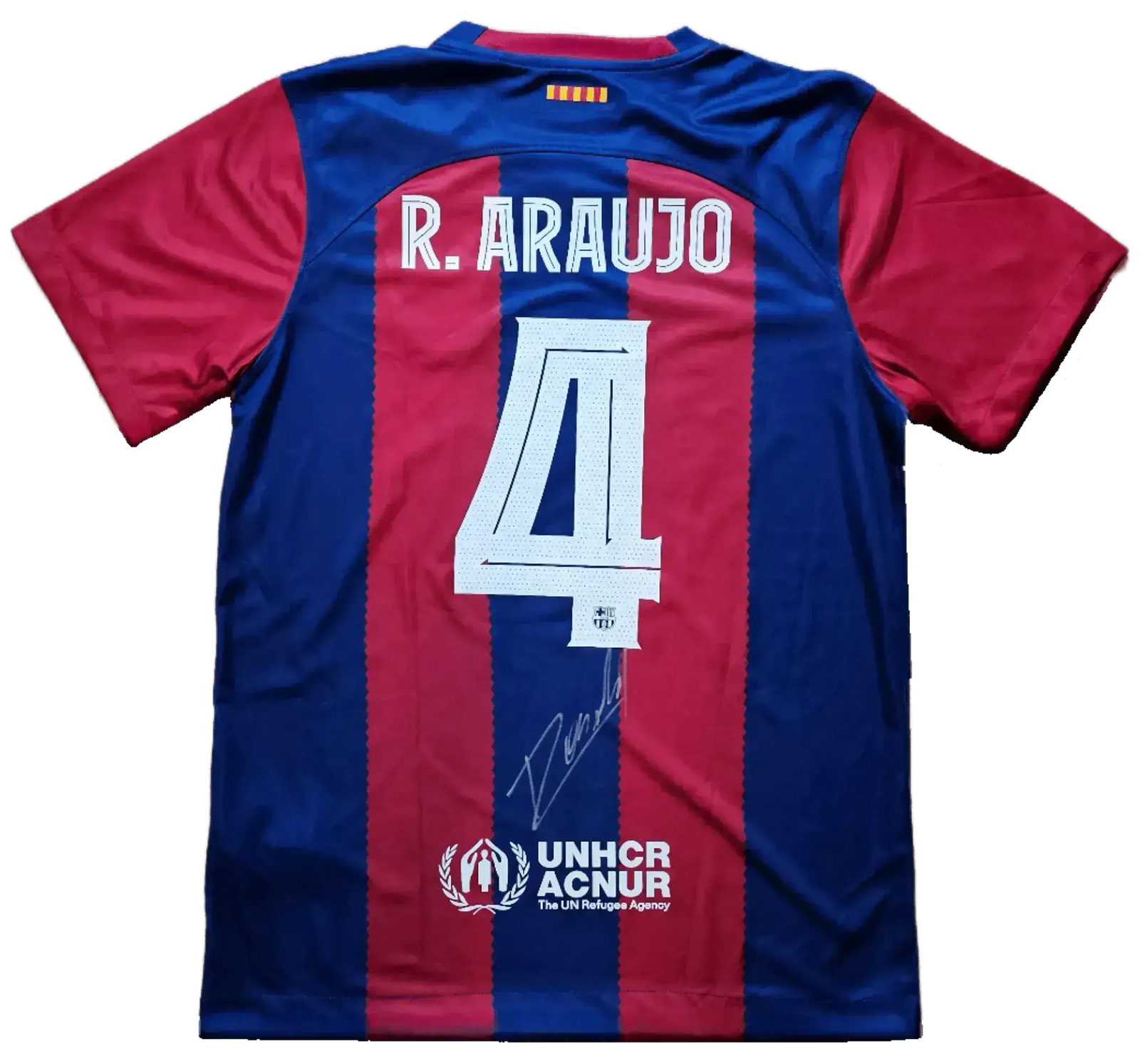 Back view featuring No. 4, R. Araujo, and signature on a blue and red striped football shirt.