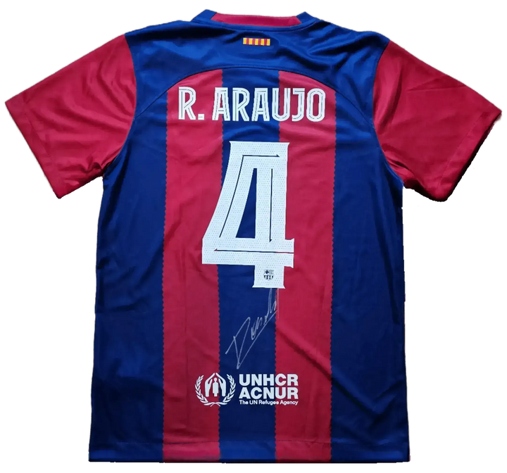 Back view featuring No. 4, R. Araujo, and signature on a blue and red striped football shirt.