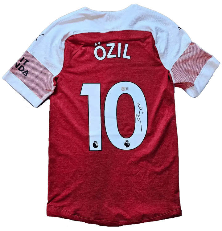Back view displaying Özil 10, Premier League logos, and a visible signature.